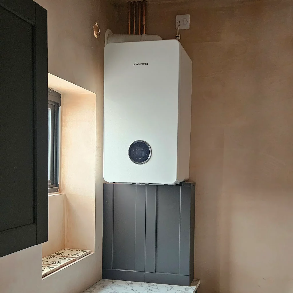 A new Worcester boliler installed in a new build house with pipe work cover